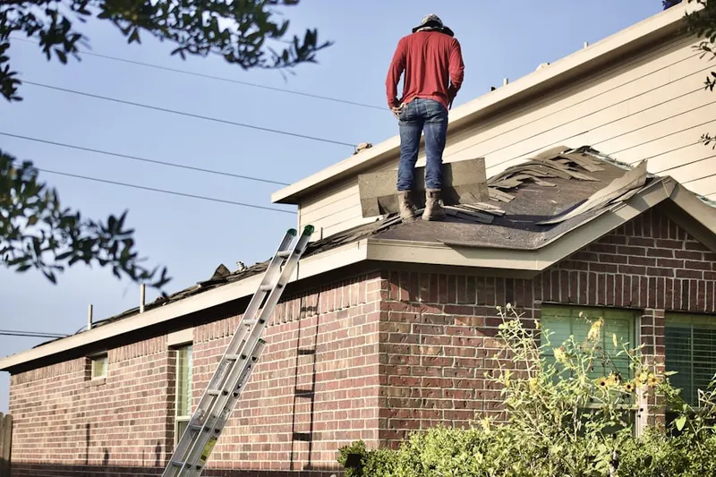 Professional roofer working on a residential roof in Parkway North